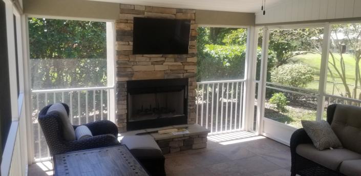 Addition of cozy screened-in porch with a fireplace added.